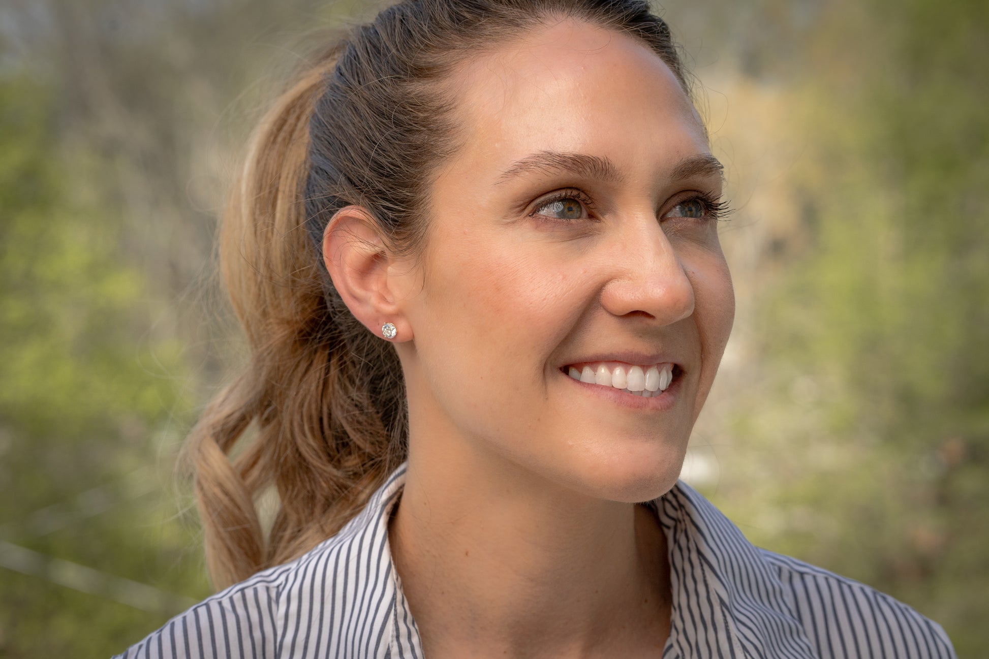 model wearing white gold 2 ct tw martini 3-prong set lab-grown diamond stud earrings