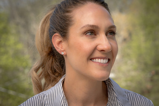 model wearing white gold 2 ct tw martini 3-prong set lab-grown diamond stud earrings