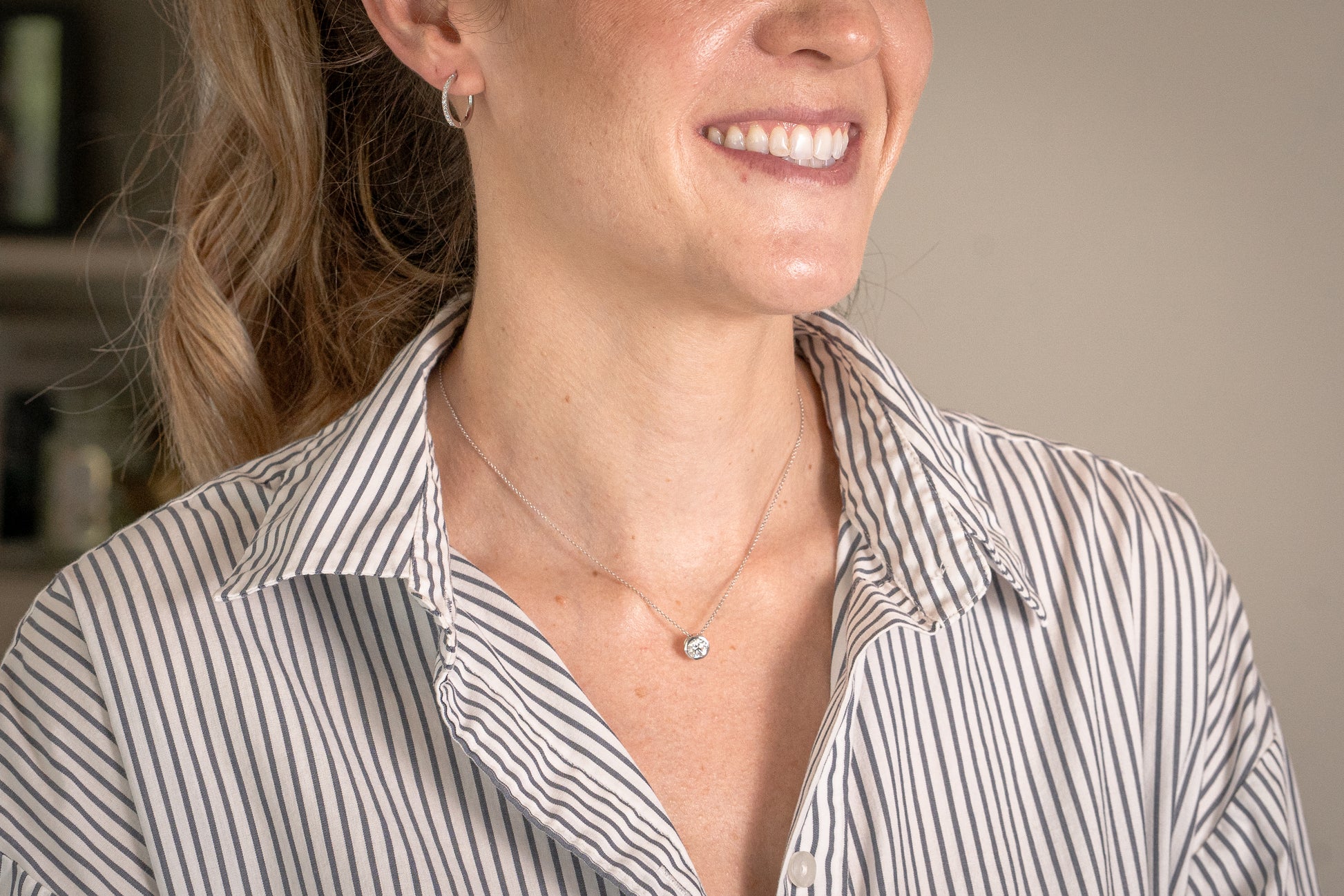 modeled - 16 mm diamond hoops and 1 carat bezel-set necklace