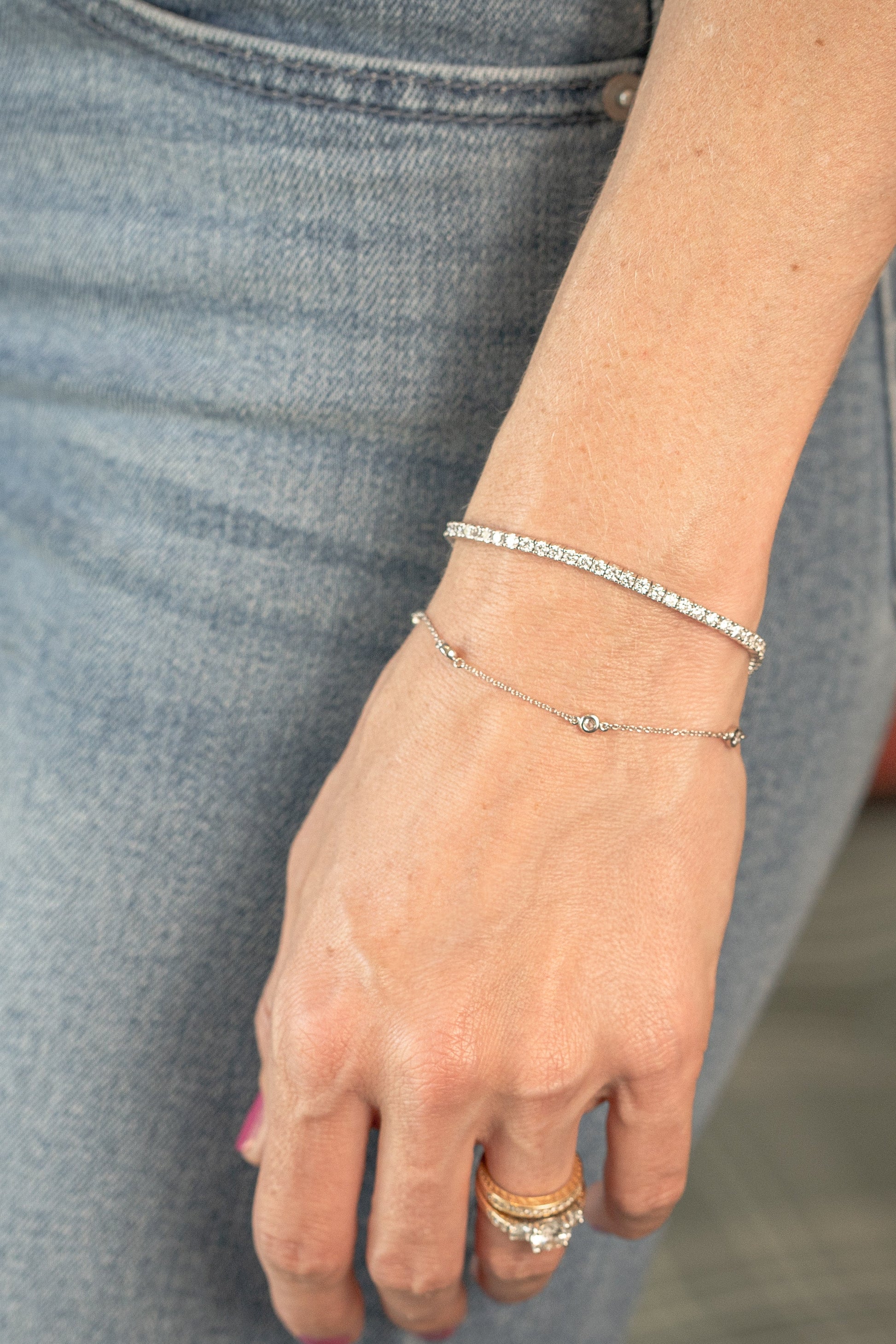 station bracelet and 4 carat tennis bracelet - both in white gold