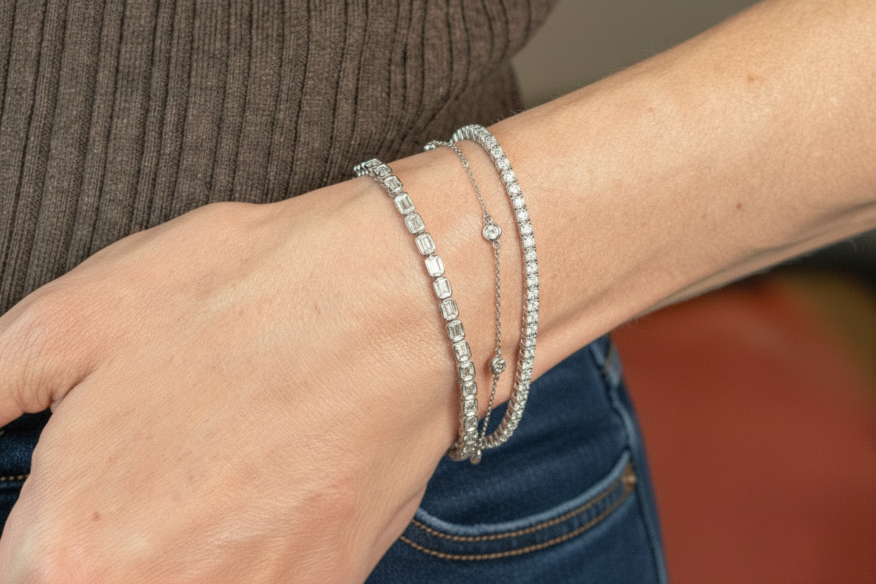 station bracelet, 4 carat tennis bracelet and 6.25 carat emerald cut tennis bracelet - all in white gold