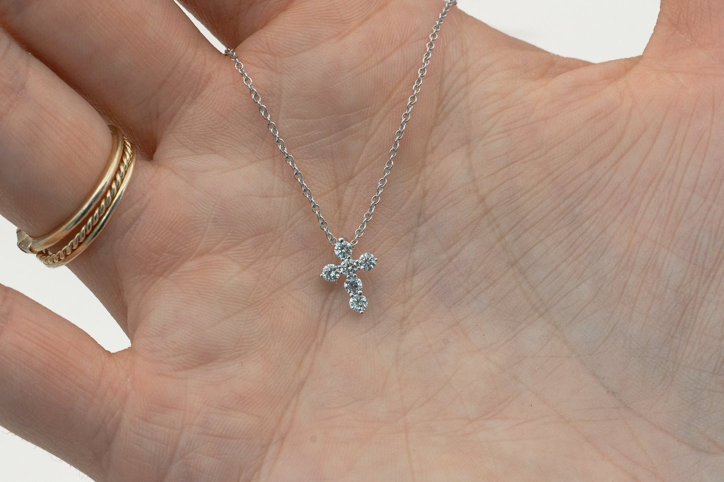 close-up of 1/4 carat cross pendant in white gold