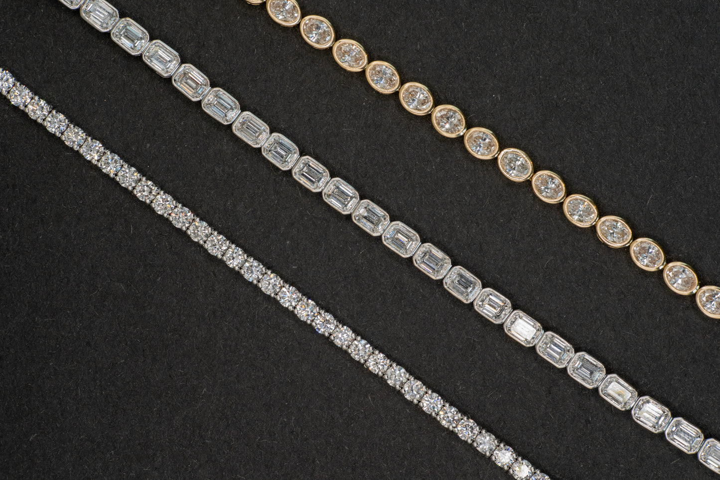 white gold 4 carat tennis bracelet, 6.25 carat white gold emerald cut tennis bracelet, and 4.9 carat yellow gold oval tennis bracelet