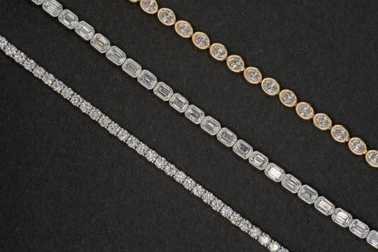 white gold 4 carat tennis bracelet, 6.25 carat white gold emerald cut tennis bracelet, and 4.9 carat yellow gold oval tennis bracelet